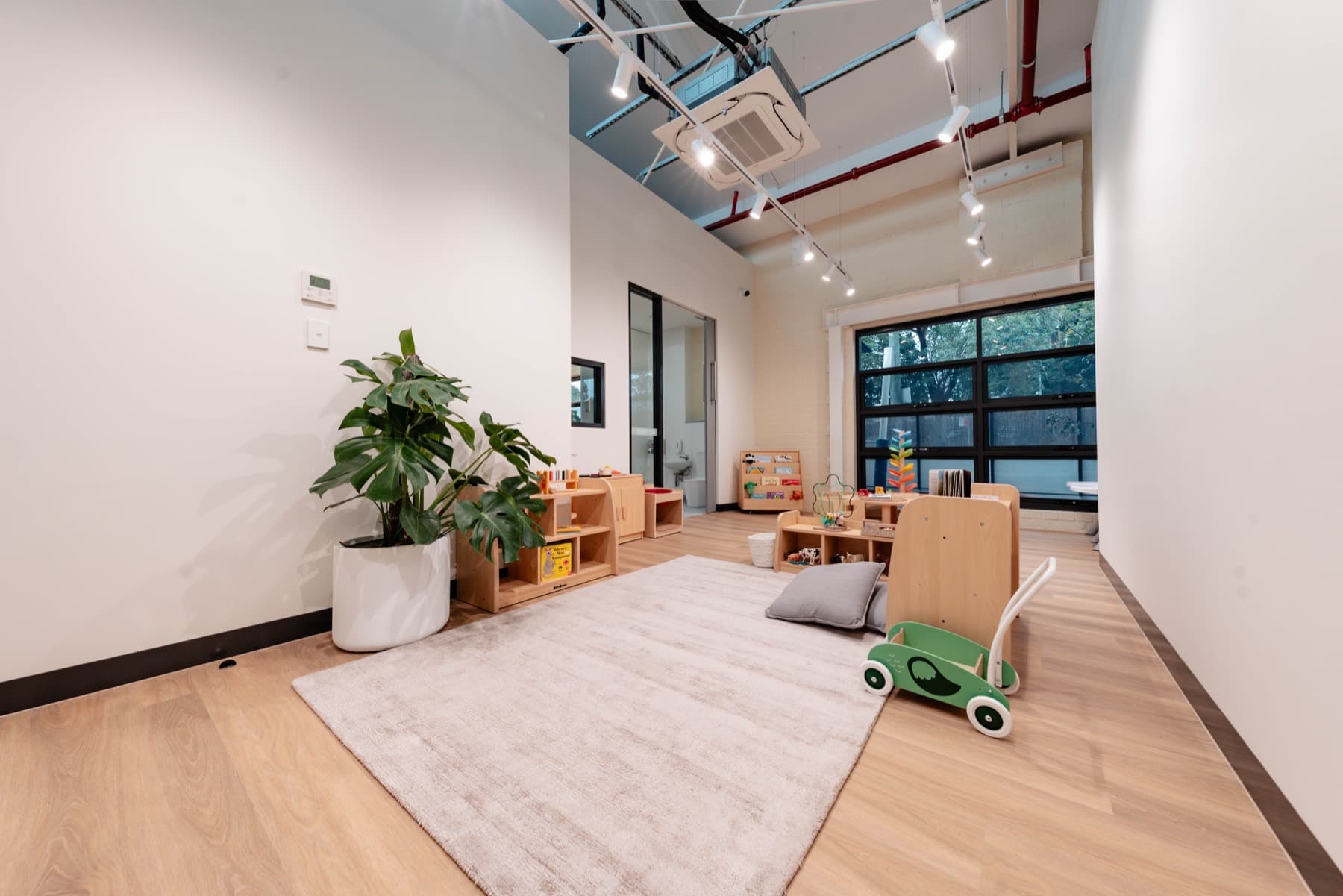 A light-filled room at Rosebery with timber furniture and a skylight
